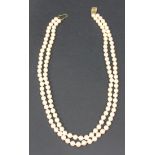 A simulated pearl two row necklace with a 9ct gold clasp, shortest length approx 43cm.