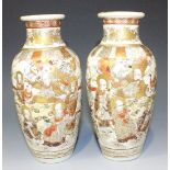 A pair of Japanese Satsuma earthenware vases, Meiji period, each painted and gilt, with opposing