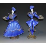 A pair of Murano glass figures of a lady and gallant, each modelled standing wearing a blue