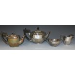 A late Victorian silver three piece tea set of oval half reeded form, comprising teapot, milk jug