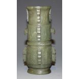 A Chinese archaistic spinach jade vase, 20th Century, of oval form, carved with taotie masks between