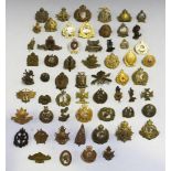 A collection of fifty-six New Zealand badges, mainly cap-size, including N.Z. Cyclist Company, M.G.