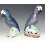 A pair of Chinese blue glazed porcelain models of parrots, late Qing dynasty, each modelled