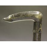 A 19th Century sectional horn walking stick with a carved handle and inset eyes, length approx