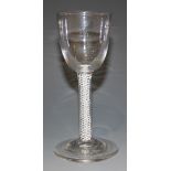 A wine glass, mid-18th Century, with cup shaped bowl, the double series opaque twist stem with