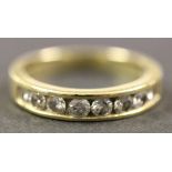 A gold and diamond set eight stone half hoop eternity ring, mounted with a row of circular cut