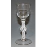 A wine glass, mid-18th Century, with ogee bowl on a knopped multiple series opaque twist stem and