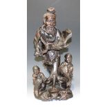 A Chinese carved hardwood figure group, late 19th/early 20th Century, modelled as a fisherman