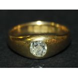 An 18ct gold and diamond single stone ring, gypsy set with a cushion shaped diamond Birmingham 1915,