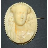 A carved ivory oval cameo brooch, possibly Dieppe, designed as the portrait of a lady wearing a