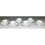 A set of six Meissen porcelain coffee cups and saucers, early 20th Century, decorated with scattered