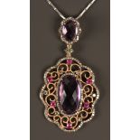 A gold, diamond, ruby and amethyst set pendant necklace, the drop mounted with the principal oval