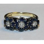 An 18ct gold, sapphire and diamond triple cluster ring, each cluster claw set with a circular cut