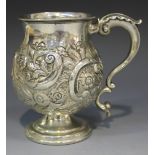 A George IV silver tankard, the baluster body relief decorated with a foliate cartouche and