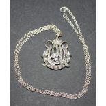 A diamond set pendant in a Middle Eastern hieroglyphic design, mounted with circular cut diamonds,