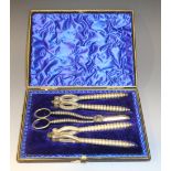 A pair of late 19th/early 20th Century plated grape shears and two pairs of nutcrackers, cased.