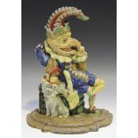 A 20th Century polychrome painted cast iron doorstop in the form of Mr Punch and Toby his dog,