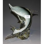 An Art glass model of a leaping dolphin supported by a wave base, height approx 25cm.