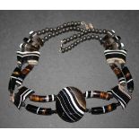 A banded agate necklace, the front with an oval agate between curved baton, oval and tapering beads,