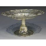 An Edwardian silver tazza of circular form, the raised sides pierced with scroll decoration within a