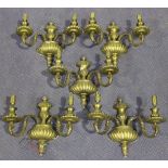 A set of five cast brass two branch wall lights with pineapple finials and reeded backplates, height