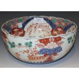 A Japanese Imari porcelain circular bowl, Meiji period, of steep sided form, painted with panels