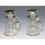 A pair of Edwardian silver mounted clear glass conical whisky tots, Birmingham 1906 by Heath &