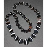 A single row necklace of forty-two graduated spherical banded agate beads, gross weight approx 164.