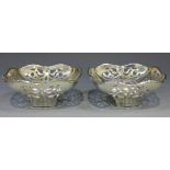 A pair of George V silver bonbon dishes, each of square form with rounded corners, the sides pierced