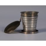 A late Victorian silver telescopic cup, collapsing down into a cylindrical box and cover, London