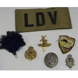 A scarce printed LDV armband, four Home Guard cap badges, comprising post-1951 Isle of Man, post-
