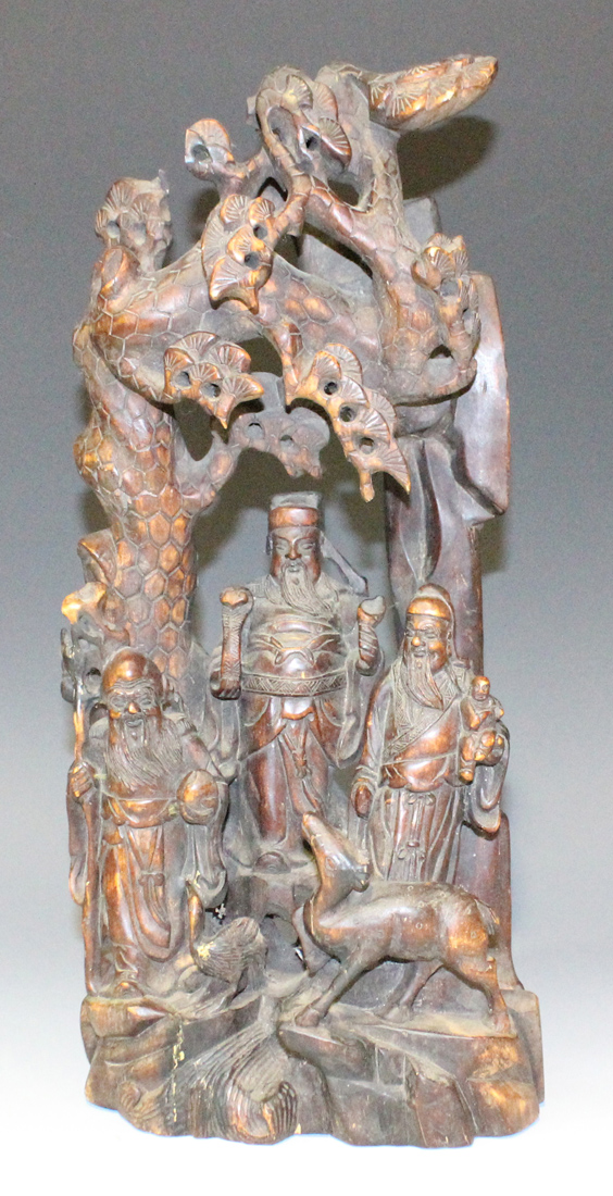 A Chinese carved wood figure group, late 19th/early 20th Century, modelled as three immortals