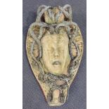 A 20th Century composition stone and applied lead wall mounted fountain in the form of the mask of