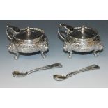 A pair of silver circular mustards, each hinged cover with knop finial above a gadrooned rim flanked