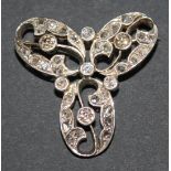 A diamond set brooch in an open work trefoil shaped design, mounted with cushion shaped and rose cut