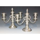 A pair of 20th Century plated two scroll branch candelabra each with detachable nozzles above drip