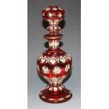 A Bohemian ruby flash overlay clear glass decanter and stopper, late 19th Century, of baluster