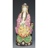 A Chinese 'clobbered' blanc-de-Chine Guanyin group, 18th Century and later, thoroughly enamelled