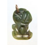 A Maori carved green stone hei-tiki pendant with 9ct gold suspension loop, height approx 2.5cm (