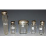 A pair of Edwardian silver and faceted glass dressing table bottles, London 1908, together with
