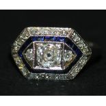 A white gold, diamond and sapphire set ring, mounted with the principal cushion shaped diamond
