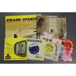 A small collection of records, including 'Christmas Dreaming' by Frank Sinatra and 'Excerpts from