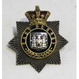 A Victorian officer's forage cap badge of the East Surrey Regiment, the four-part silvered and