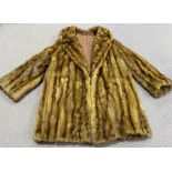 A mid-20th Century brown fur half-length coat with brown fabric lining, length approx 62cm, together