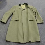 A late 20th Century green fabric gentleman's long coat with velvetine collar, bearing labels