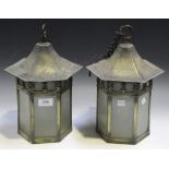 A pair of early 20th Century Arts and Crafts style hexagonal brass framed lanterns with domed tops