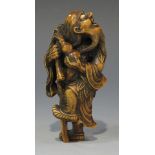 A Japanese carved wood okimono netsuke, 20th Century, finely modelled as a blind beggar, carrying