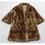 A mid-20th Century brown fur three-quarter length coat, the interior bearing label marked 'John Dunn