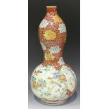 A Japanese Imari porcelain vase, Meiji period, of double gourd shaped form, painted with panels of