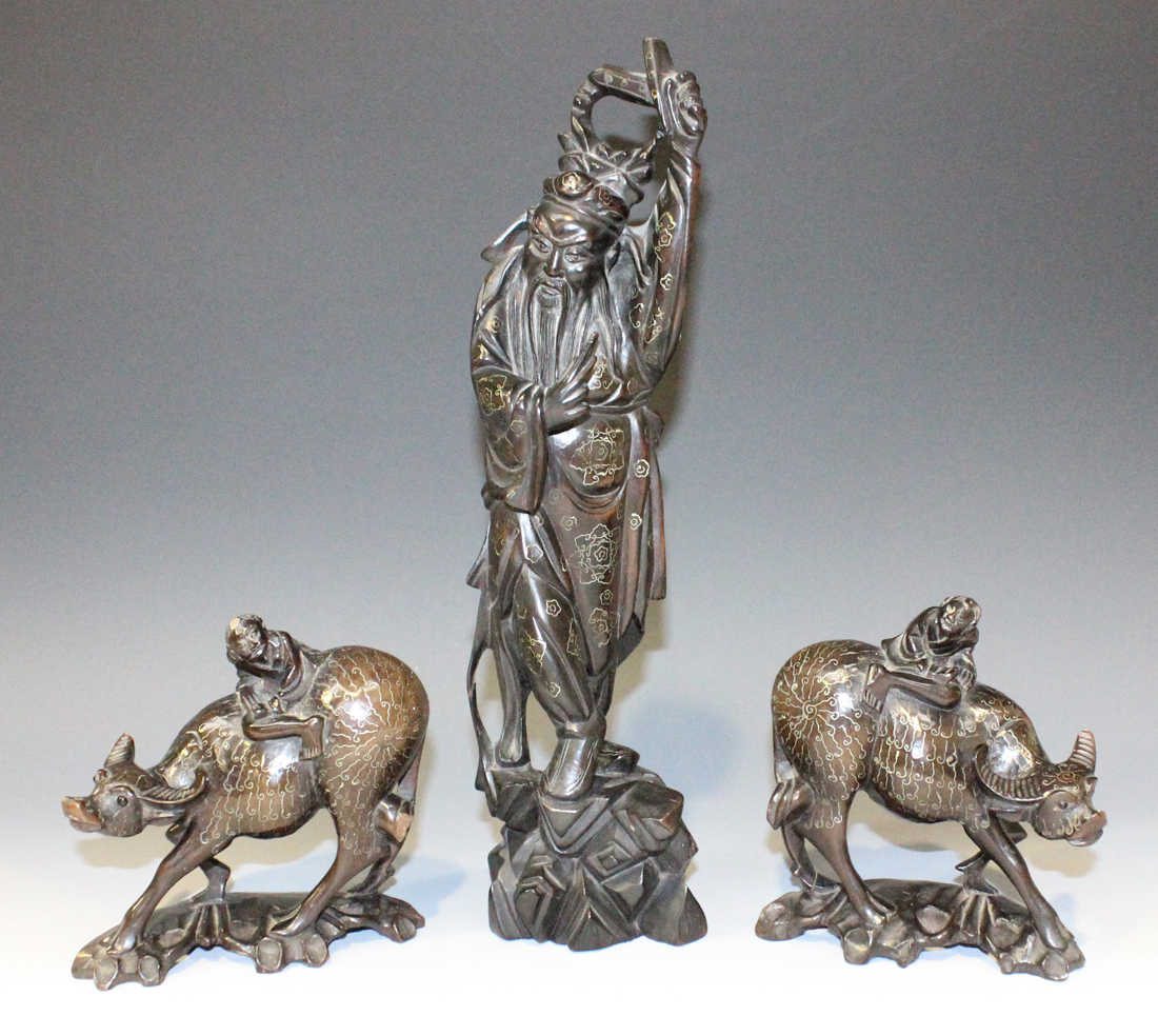 A group of three Chinese wire inlaid carved hardwood figures, late 19th/early 20th Century,